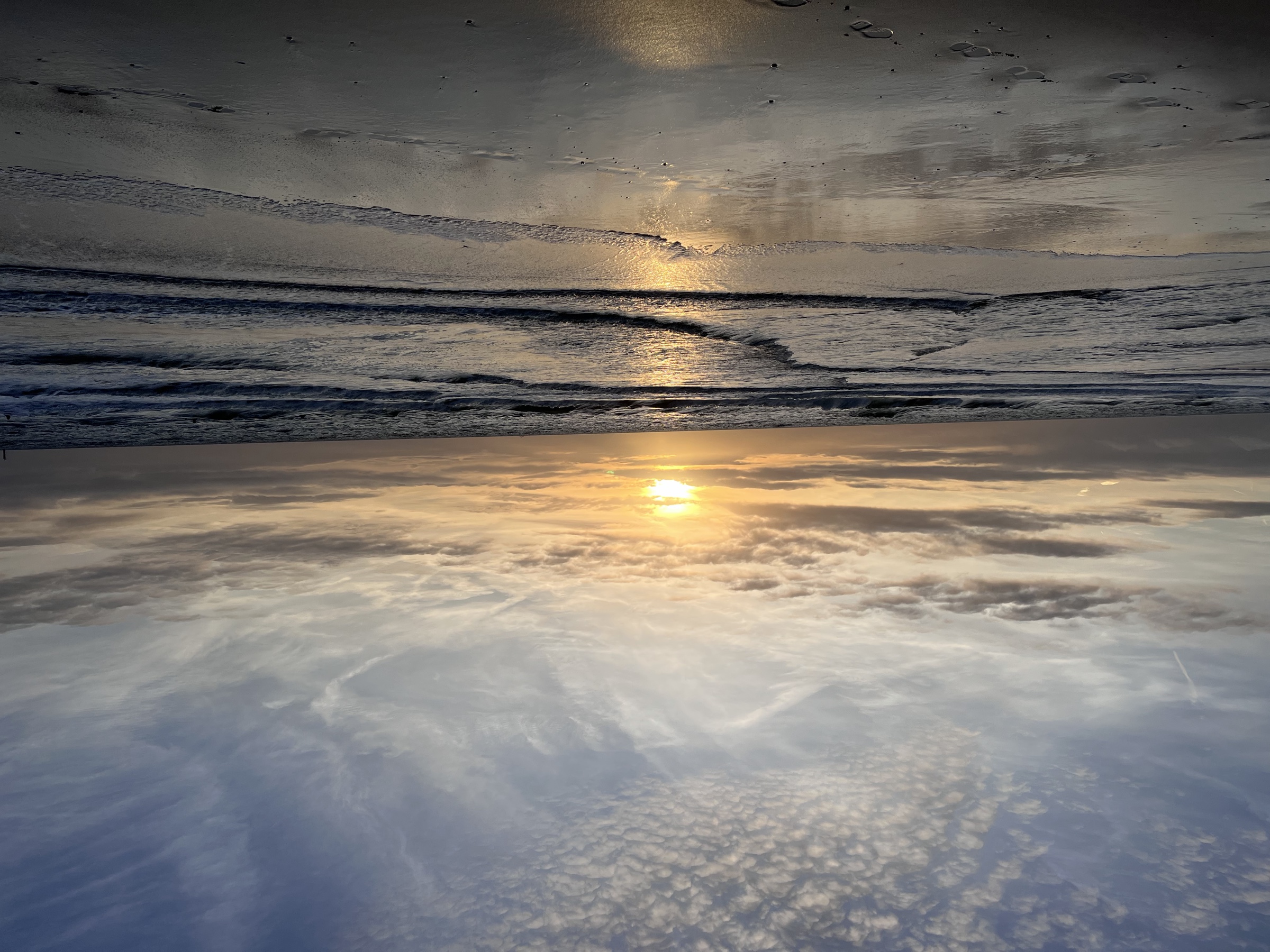 Sunset reflection on wet sand
